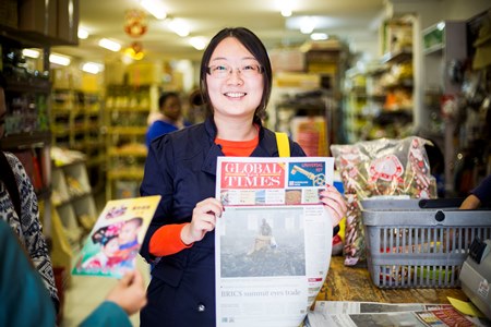 A visiting Chinese journalist in the Wits Africa China Reporting Project displays her story published in a Chinese newspaper in South Africa